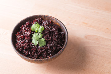 Steamed rice berry on wood bowl wood background