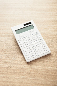 calculator on the wooden desk.