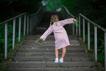 cute funny girl child walks on stairs, summer,childhood