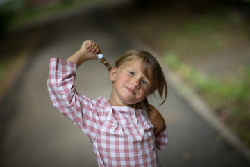 very funny cute girl showing tongue, with pigtails