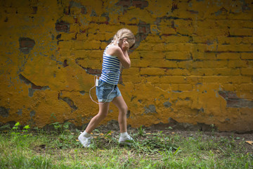  girl child listening to music with  headphones