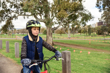 Naklejka premium Boy riding bicycle in Adelaide CBD