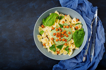 Vegan Farfalle pasta with spinach  sauce with fried chickpeas. Proper nutrition. Sports nutrition....