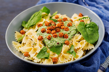 Vegan Farfalle pasta with spinach  sauce with fried chickpeas. Proper nutrition. Sports nutrition. Dietary menu.