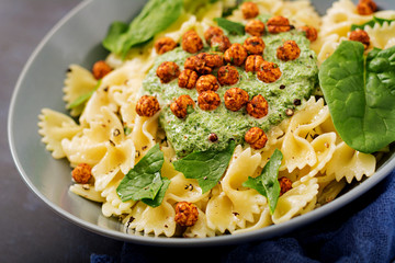 Vegan Farfalle pasta with spinach  sauce with fried chickpeas. Proper nutrition. Sports nutrition. Dietary menu.