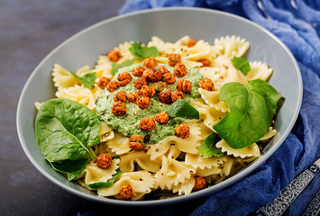 Vegan Farfalle pasta with spinach  sauce with fried chickpeas. Proper nutrition. Sports nutrition. Dietary menu.