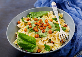 Vegan Farfalle pasta with spinach  sauce with fried chickpeas. Proper nutrition. Sports nutrition. Dietary menu.
