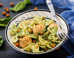 Farfalle pasta with meatballs and spinach  sauce with fried chickpeas. Proper nutrition. Sports nutrition. Dietary menu.