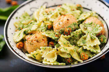 Farfalle pasta with meatballs and spinach  sauce with fried chickpeas. Proper nutrition. Sports nutrition. Dietary menu.