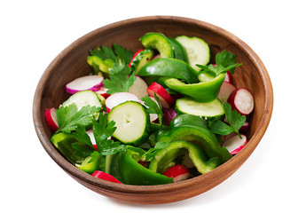 Fresh salad of cucumbers, radishes, green peppers and parsley.