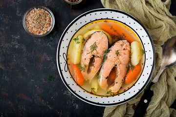 Salmon fish soup with vegetables in bowl. Flat lay. Top view