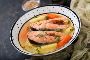 Salmon fish soup with vegetables in bowl.