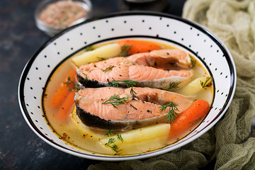 Salmon fish soup with vegetables in bowl.