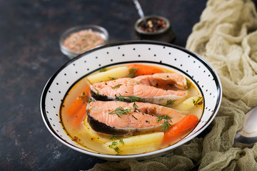 Salmon fish soup with vegetables in bowl.
