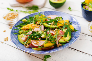 Holiday salad with smoked chicken, mango, avocado and arugula. Flat lay. Top view