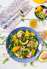 Holiday salad with smoked chicken, mango, avocado and arugula. Flat lay. Top view