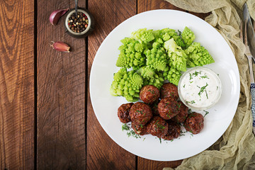Baked beef meatballs and garnish from boiled cabbage romanesko. Dietary menu. Proper nutrition. Flat lay. Top view
