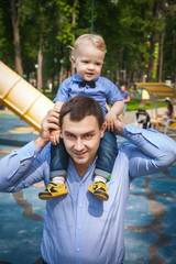 father and son walking in park