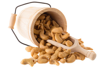 Closeup of cashew nuts in a Wooden buckets isolated on white background