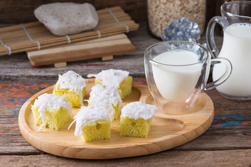 Coconut cake on wooden plate.