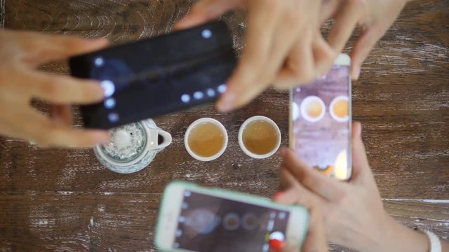 Young Friends Taking Photo of Traditional Chinese Tea Ceremony with Mobile Phone. Serving Tea Drinking view from Above. 4K.