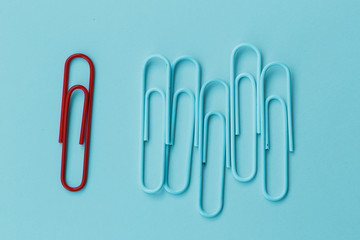 outstanding red clip on blue background horizontal shapes for copy space. minimal concept. Ideas about showing leadership in various ways. or education