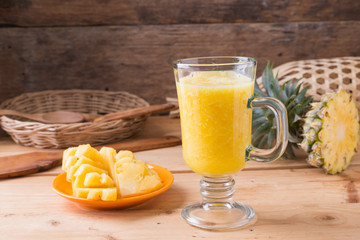 Pineapple smoothie  on wood background
