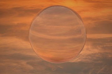 Reflecting sphere over sunset sky