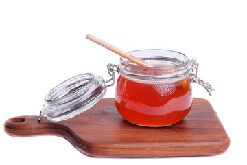 Fresh honey in jar isolated on white background