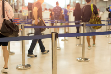 Fototapeta na wymiar Passengers walking through check-in line at the airport