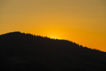 Fototapeta na wymiar Sunrise against the background of the Carpathian mountains in the summer. Ukraine