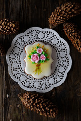 homemade gingerbread cookie with the handmade icing flowers decoration on a wooden table