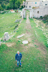 High angle view of man standing in town of Old Perithia. Corfu, Greece.