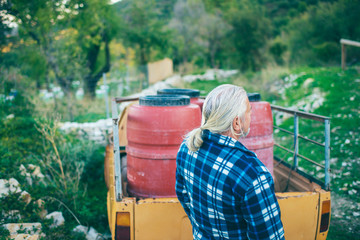 Middle aged man with grey hair and beard at trailer of vintage pick-up truck.