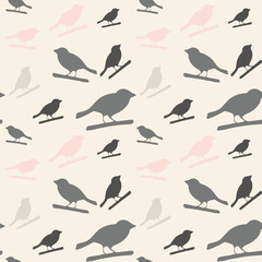Birds pattern. Vector seamless pattern with hand drawn silhouettes of birds on a tree branch.