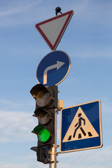 Green traffic signal, road signs