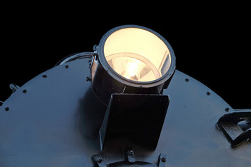 glowing headlight of the locomotive.isolated on black