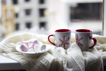 Marshmallows with a couple of christmas coffee cups