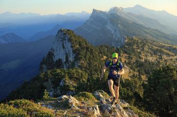 Athlete trailrunning in the mountains on a beautiful afternoon. Vercors, France.