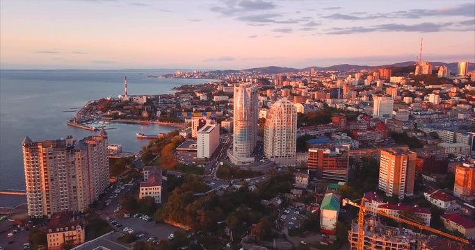 Aerial view of Vladivostok city center, Egersheld peninsula. Russia. Peter the Great Gulf (sea of Japan) is on the left and Golden Horn bay with Golden Bridge across it is on the right. Evening