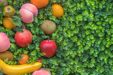Colorful fruit on green grass, background