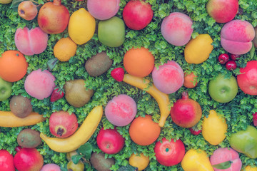 Fototapeta na wymiar Colorful fruit on green grass, background