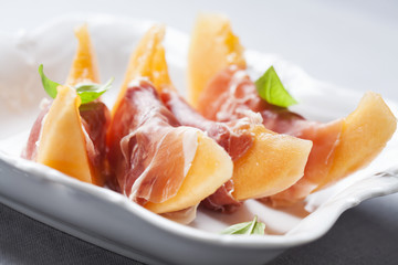 Slices of cantaloupe melon and prosciutto ham, shallow DOF