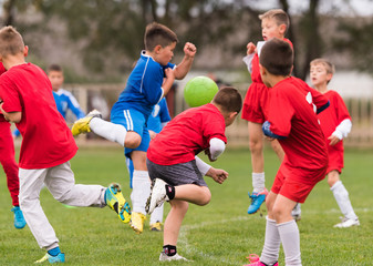 Young children players football match on soccer field