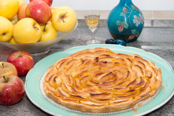 beautiful apple pie with apples and glass of Calvados