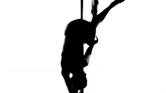 amazing pole dancer showing her skills against a white background