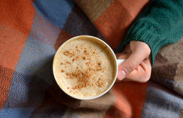 Girl with cup of cappuccino coffee