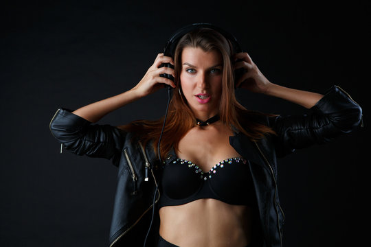 Studio photo of young woman wearing headphones, underwear