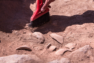 Archaeological tools, Archeaologist working on site, close-up, hand and tool