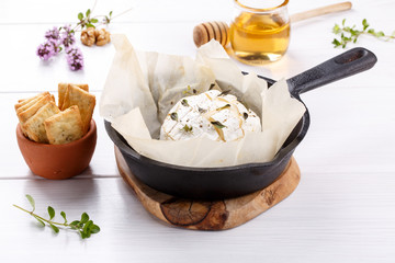 Baked camembert cheese with thyme and pepper